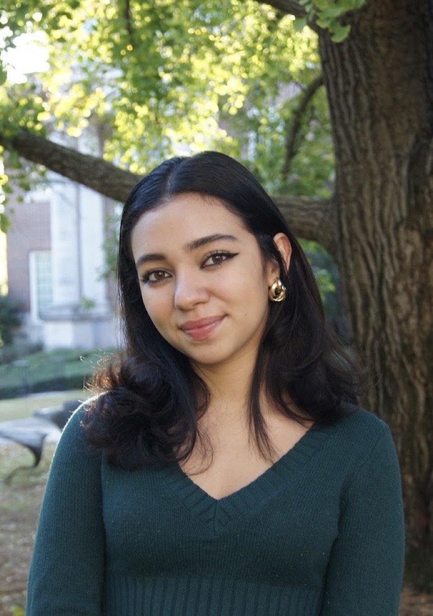 Portrait of Daniela Videa outdoors in a green sweater
