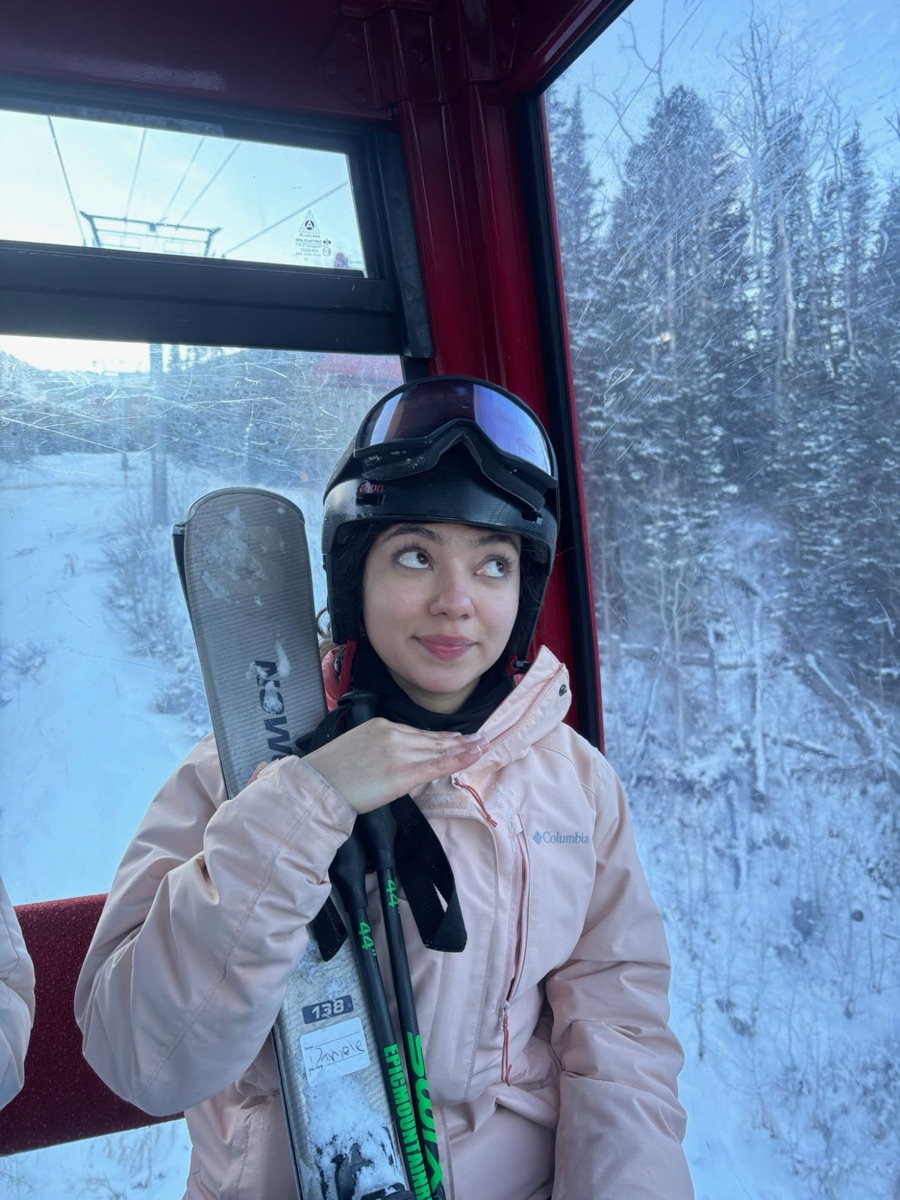 Daniela Videa in a ski gondola holding her skis